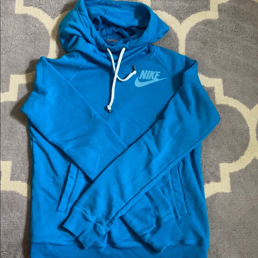 Turquoise Nike funnel-neck hooded sweatshirt.